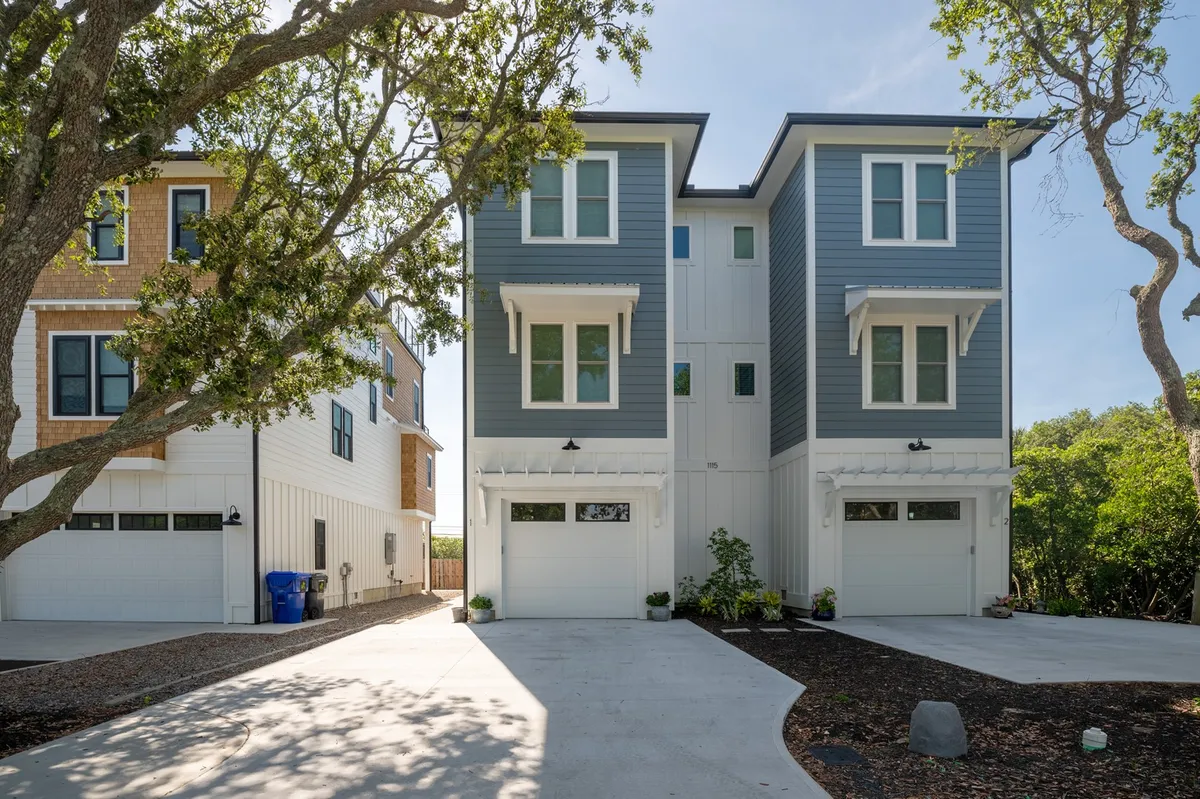 A modern exterior view of a residence characterized by clean architectural lines, lush greenery, and a spacious driveway. The inviting landscape implies a welcome home after a day of local exploration, hinting at gatherings and relaxation on sunny afternoons.